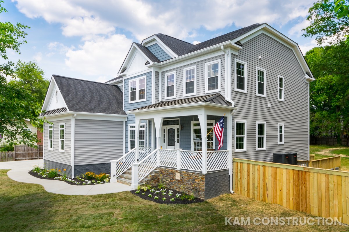 Finished home exterior with gray and blue siding and covered porch